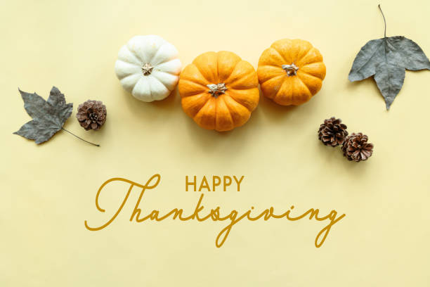istock Happy Thanksgiving Day with pumpkin and maple leaf 1287755424