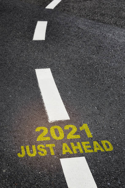 istock 2021 just ahead written on road surface with marking line 1287763678