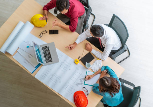 istock Three contractor builder team having a successful meeting in office, Top view shot. 1287765332