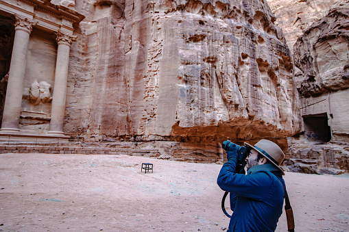 Traveler exploring and taking pictures in a famous tourist spot, Petra