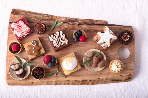 Vegan, gluten-free, organic candy and non-Vegan holiday desserts on handmade wood serving board.  North Vancouver, British Columbia, Canada.