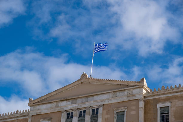 istock Greek flag waving against blue sky background. 1287768887