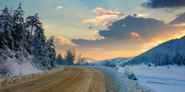 istock road through mountain landscape in winter 1287769043