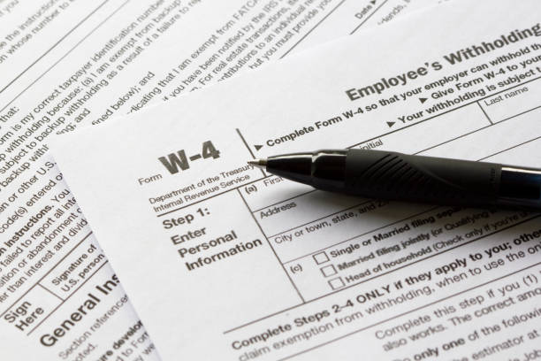 Form W-4 Close up of Form W-4, Employee's Withholding Certificate. irs office stock pictures, royalty-free photos & images