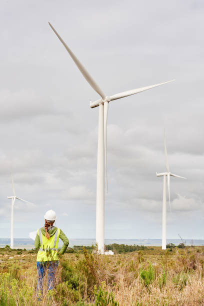 istock Engineer looking up at a wind turbine in a power generation station 1287771694