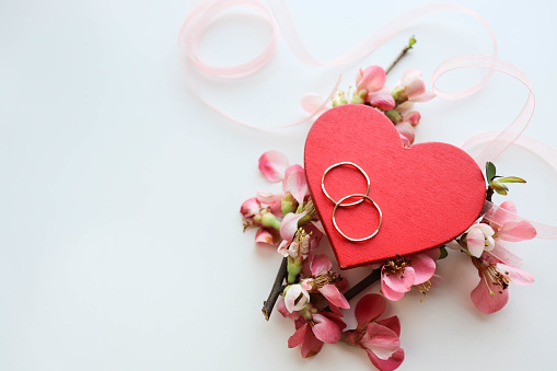 valentine's day concept. wedding card. red heart, flowers and wedding ring on white background