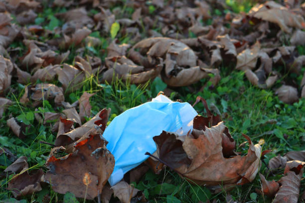 istock Medical protective face mask on green grass 1287774357