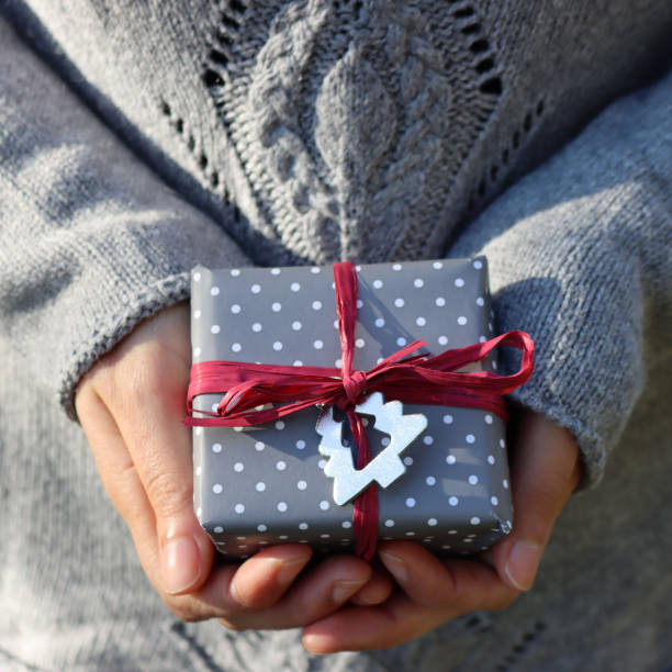 istock Female hands holding gift box for Christmas 1287774548