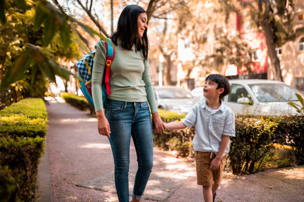istock Mother and son walking in the park 1287774720