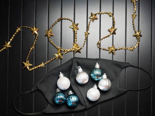 istock Black face mask decorated with christmas ornaments and number 2021 1287778654