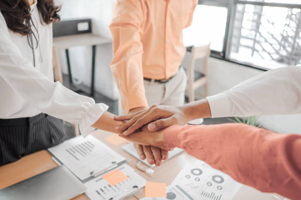 istock Businesspeople teamwork group putting their hands together agreement plan in meeting room, investment concept, success concept