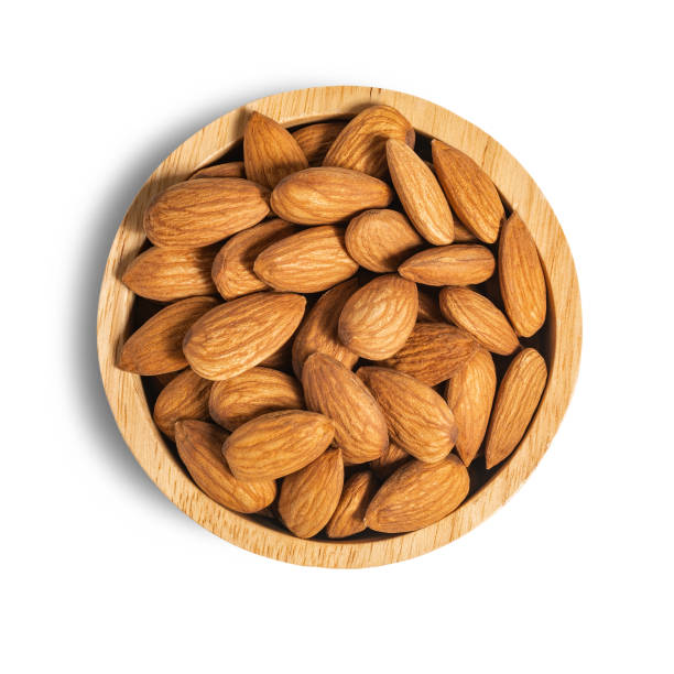 istock Almond in wooden cup isolated on white background with clipping path. 1287779516