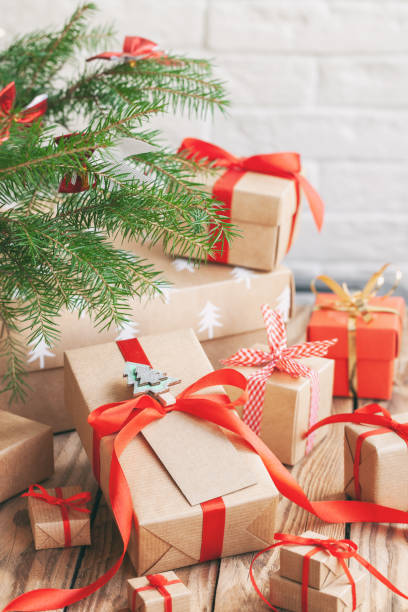istock Many Handmade zero waste Christmas gift boxes under fir tree on floor in room 1287786835