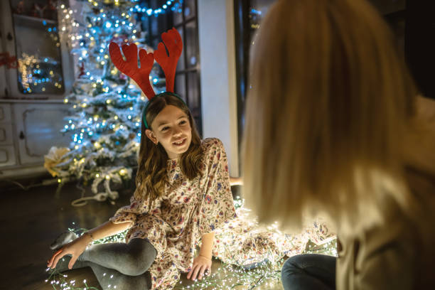 istock Mother and girl on a Christmas night 1287787165
