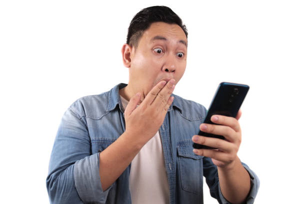 istock Young Man Texting Reading Chatting on His Phone Surprised Gesture 1287787448