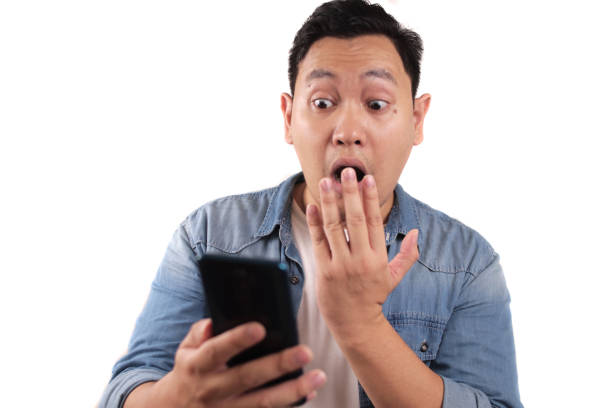istock Young Man Texting Reading Chatting on His Phone Surprised Gesture 1287787509