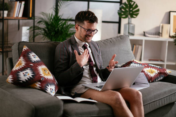 istock Businessman with no pants working at home. 1287788375