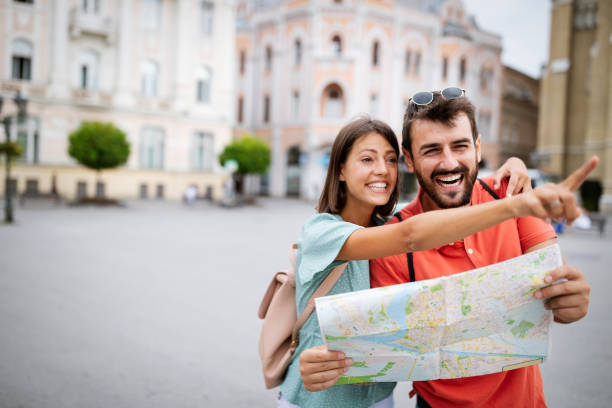 istock Happy couple on vacation sightseeing city with map 1287788874