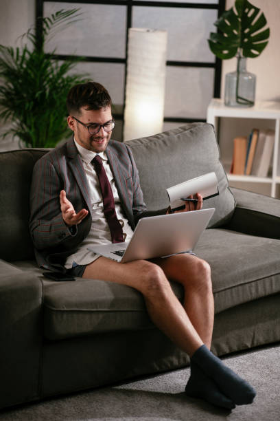 istock Businessman with no pants working at home. 1287789238