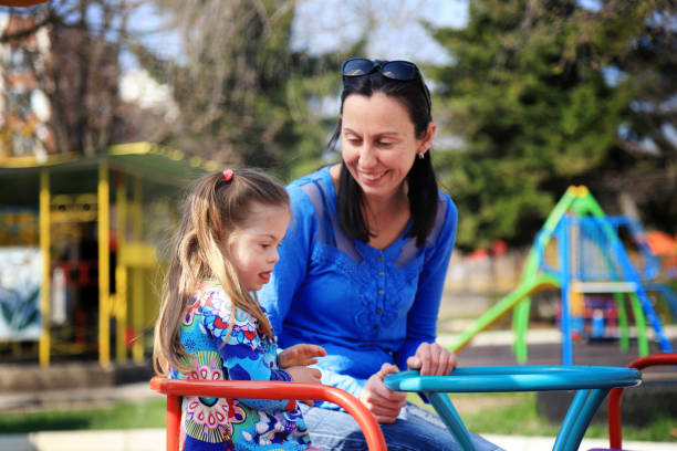 istock Mother and her daughter having fun in a playground 1287791119