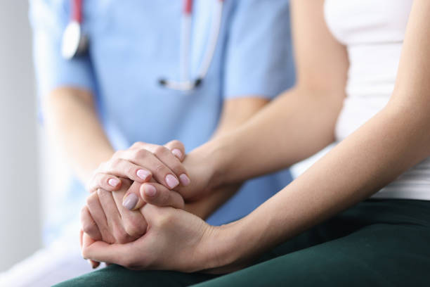 istock Patient's and doctor's hands are folded together. 1287793536
