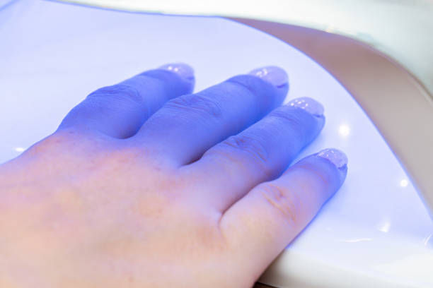 istock Drying nails after applying varnish in a special ultraviolet dryer 1287794635