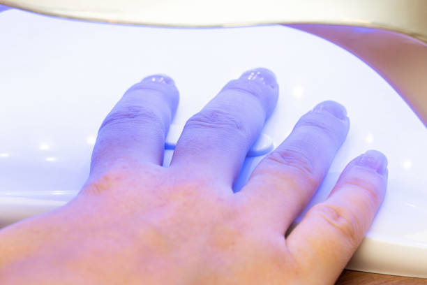 istock Drying nails after applying varnish in a special ultraviolet dryer 1287794636