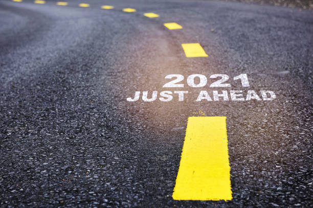istock 2021 just ahead written on road surface with marking line 1287797343