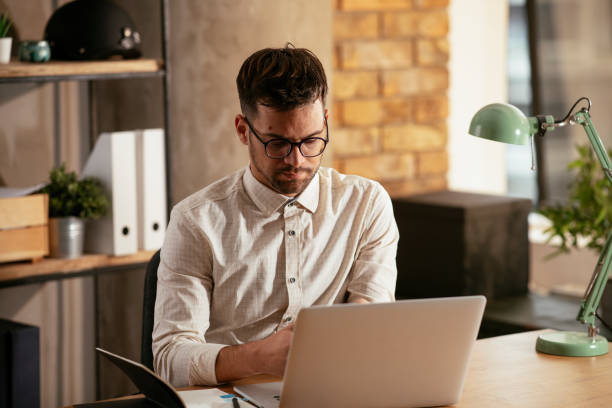 istock Businessman working in the office on his laptop. 1287799471