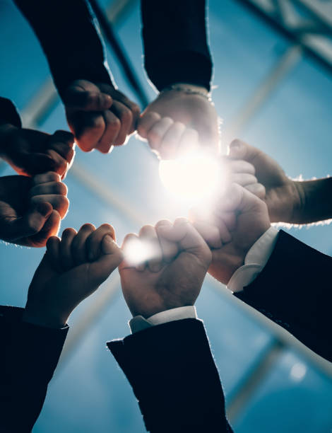 istock close up. young business people showing their unity 1287800513