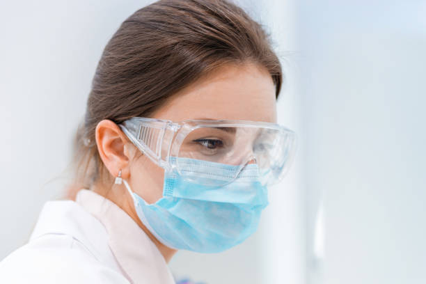 istock close up. female scientist in a protective mask 1287800792