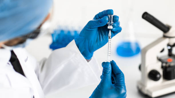 istock close up. scientist filling a syringe with a new vaccine 1287802463