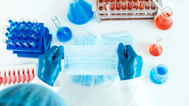 istock close up. protective mask in the hands of an epidemiologist 1287802476
