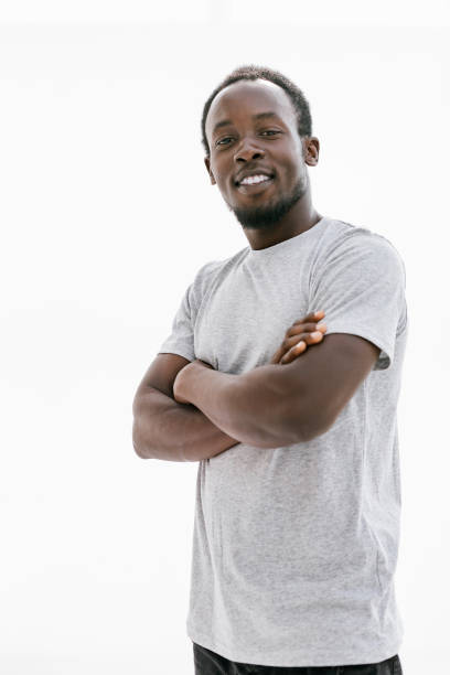 istock confident young man in a white t-shirt. isolated on white 1287802566