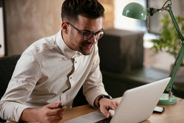 istock Businessman working in the office on his laptop. 1287803399
