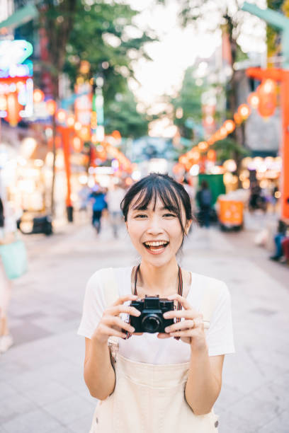 istock Taiwanese woman taking photos with a retro camera 1287805988