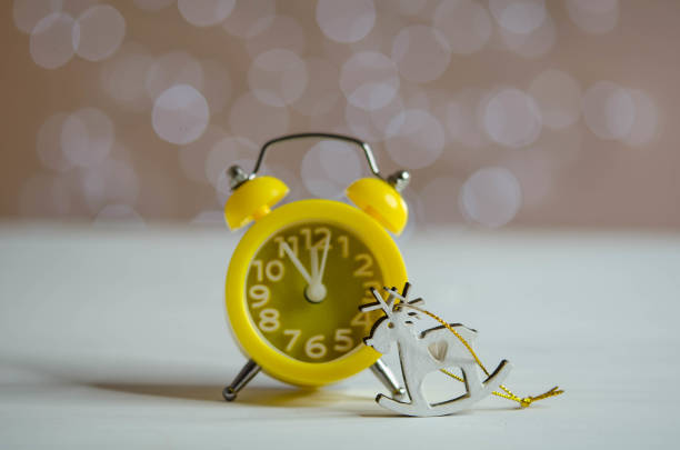 istock Yellow alarm clock on the table. Bokeh. 1287806148