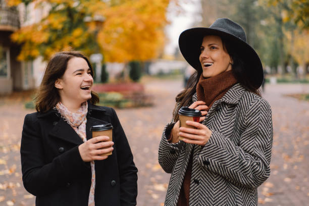istock Girls drinking coffee in the park. 1287806350