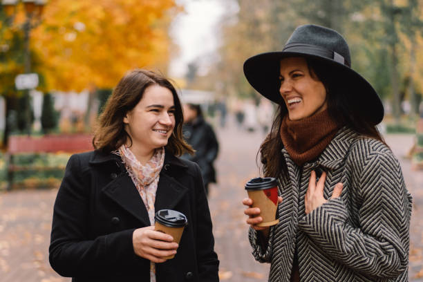 istock Girls drinking coffee in the park. 1287806445