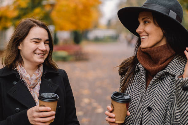 istock Girls drinking coffee in the park. 1287806525