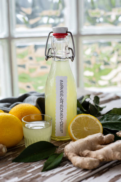 istock Fresh ginger lemon syrup with whole lemons and ginger roots 1287806658