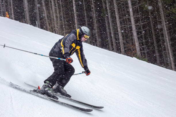istock A skier goes down the black track during a blizzard. 1287806785