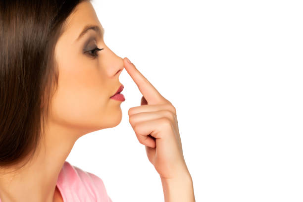 istock Young beautiful woman touches her nose 1287812425