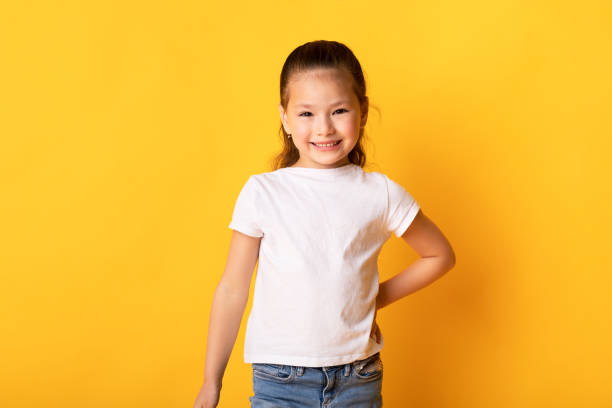 istock Smiling asian girl posing and looking at camera 1287820737