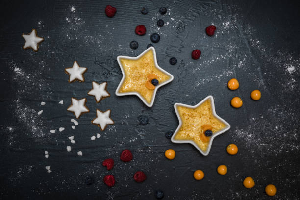 istock Two star shaped forms with creme brulee, served with berries and christmas cookies 1287821441