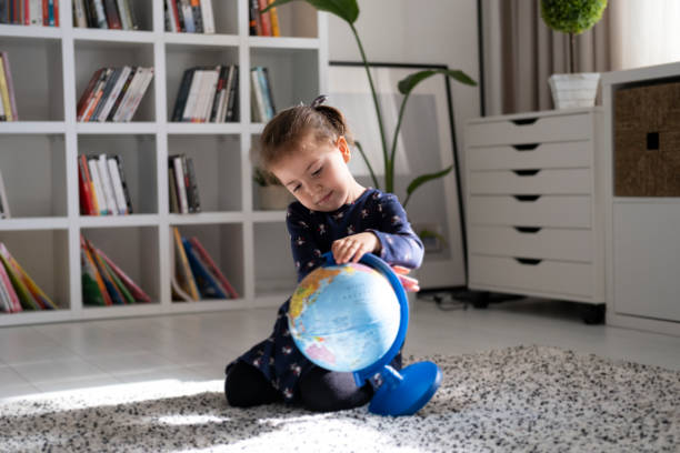 istock Little girl examines the map 1287821700