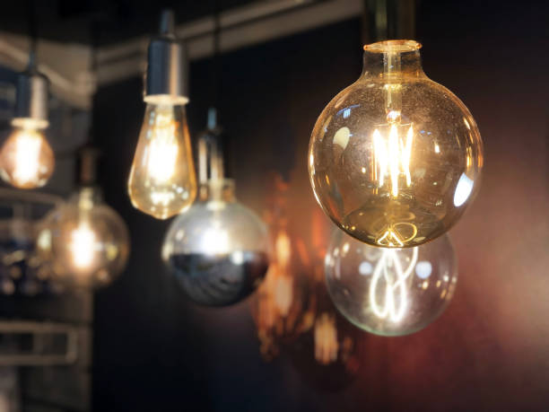 istock Light bulbs on a black background. Lights on. Light design. Idea concept 1287821759