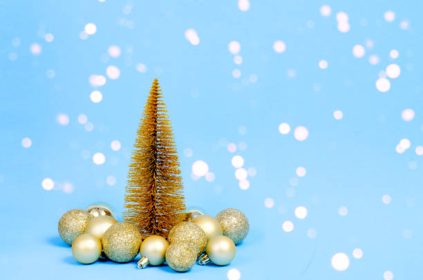 istock Golden Christmas tree with Christmas decorations on blue background with bokeh lights. Christmas concept. Christmas card. 1287822691