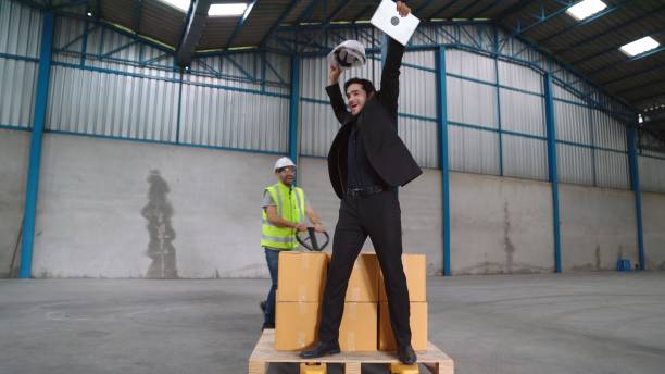 istock Funny factory workers dance in the factory 1287823813