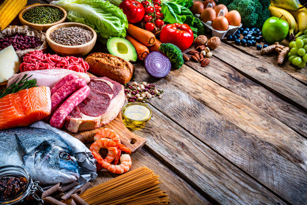 istock Group of healthy food on rustic wooden table. Copy space 1287823939